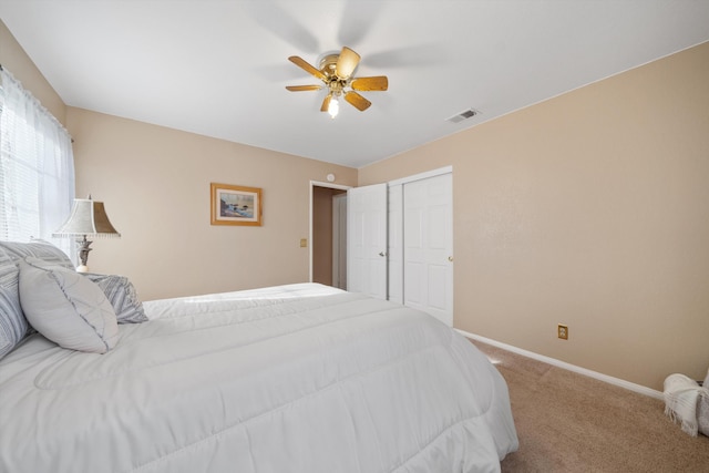 carpeted bedroom with a closet and ceiling fan