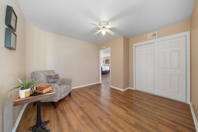 sitting room featuring ceiling fan and hardwood / wood-style flooring