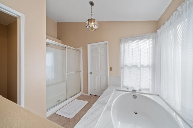 bathroom featuring independent shower and bath and vaulted ceiling