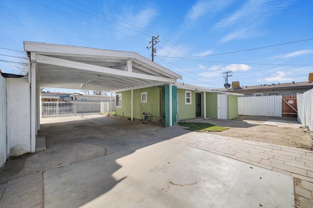 view of front of house featuring a carport and a storage shed