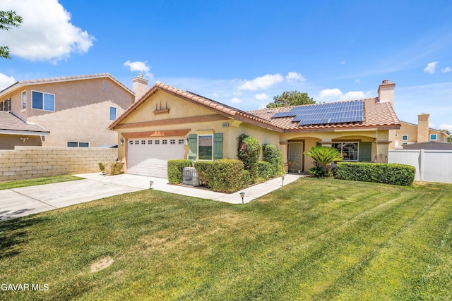 43432 Bale Ct, Lancaster, CA 93535 - view of front of property featuring roof mounted solar panels, concrete driveway, an attached garage, stucco siding, and a chimney