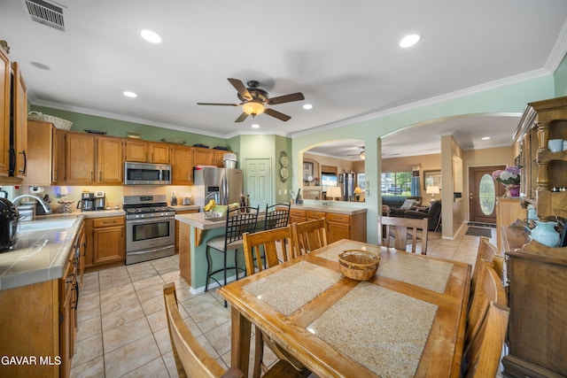 43432 Bale Ct, Lancaster, CA 93535 - kitchen with stainless steel appliances, arched walkways, tile countertops, ceiling fan, and recessed lighting