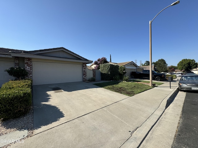25561 Alicante Dr, Santa Clarita, CA 91355 - ranch-style house with concrete driveway, a garage, and stone siding