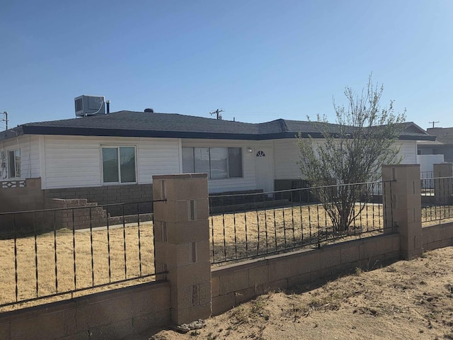 ranch-style home with central AC and a fenced front yard
