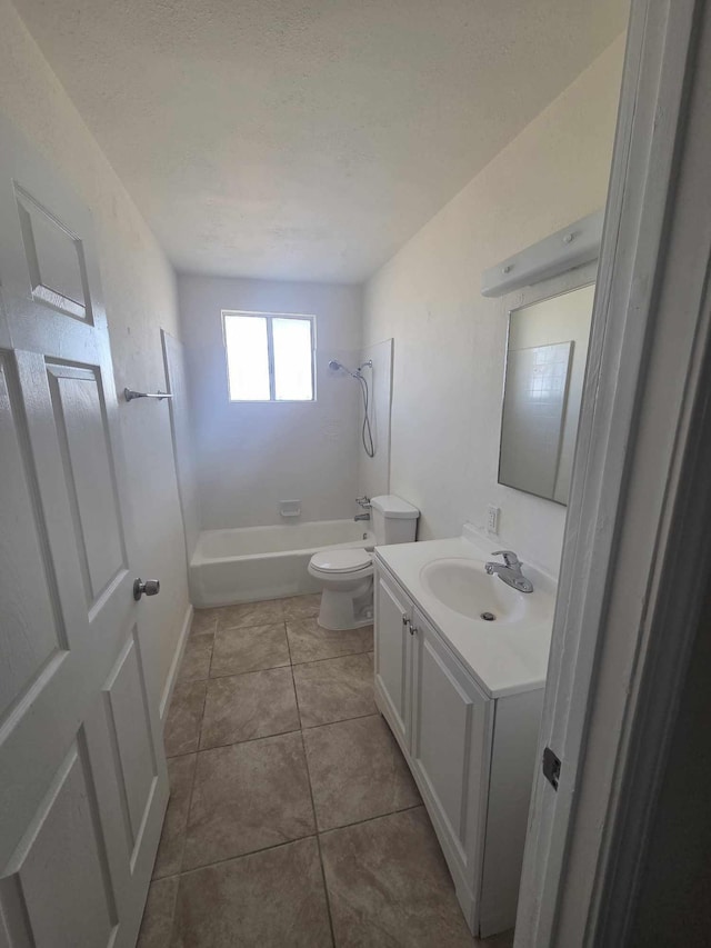 bathroom with toilet, vanity,  shower combination, and tile patterned floors