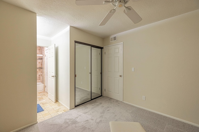 28367 Mount Stephen Ave, Santa Clarita, CA 91387 - unfurnished bedroom featuring carpet flooring, connected bathroom, a closet, a textured ceiling, and ceiling fan