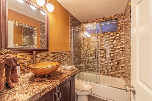 28367 Mount Stephen Ave, Santa Clarita, CA 91387 - full bathroom with toilet, vanity, bath / shower combo with glass door, and backsplash