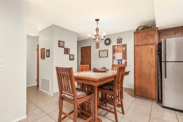 1037 Herzel Ave, Lancaster, CA 93535 - dining room featuring light tile patterned floors, a chandelier, and a textured ceiling