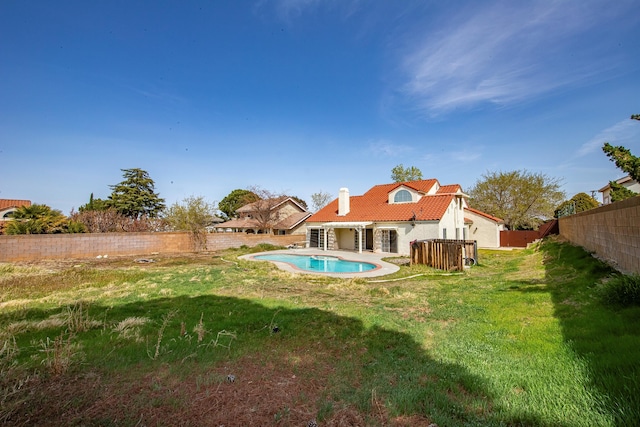 42443 Surrey Ct, Quartz Hill, CA 93536 - rear view of property featuring a tile roof, a chimney, and stucco siding