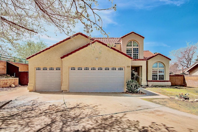 42443 Surrey Ct, Quartz Hill, CA 93536 - mediterranean / spanish-style home with an attached garage, driveway, stucco siding, and a tiled roof