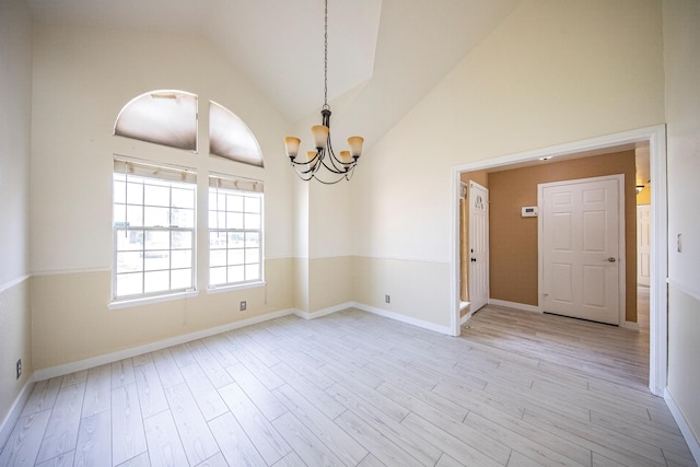 42443 Surrey Ct, Quartz Hill, CA 93536 - spare room with a chandelier, light wood-style flooring, high vaulted ceiling, and baseboards