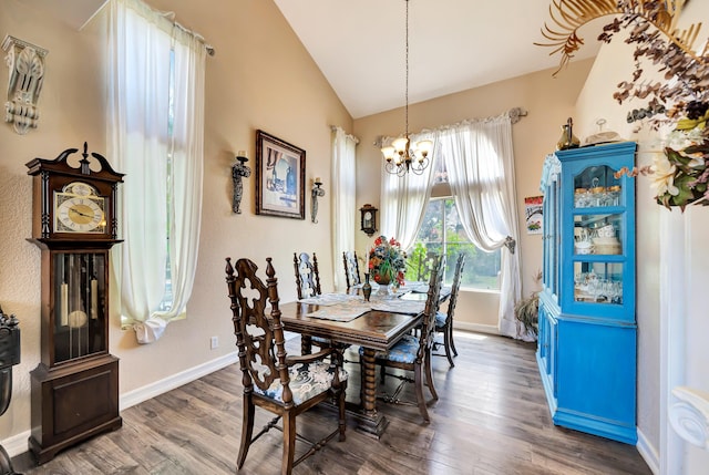 39884 Golfers Dr, Palmdale, CA 93551 - dining space featuring lofted ceiling, a chandelier, wood finished floors, and baseboards