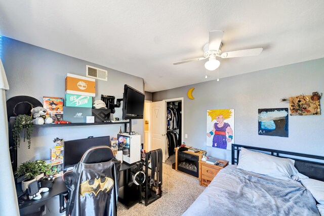39884 Golfers Dr, Palmdale, CA 93551 - bedroom with light colored carpet, a spacious closet, ceiling fan, an office area, and a closet