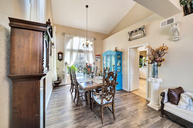 39884 Golfers Dr, Palmdale, CA 93551 - dining space with vaulted ceiling, wood finished floors, a chandelier, and baseboards
