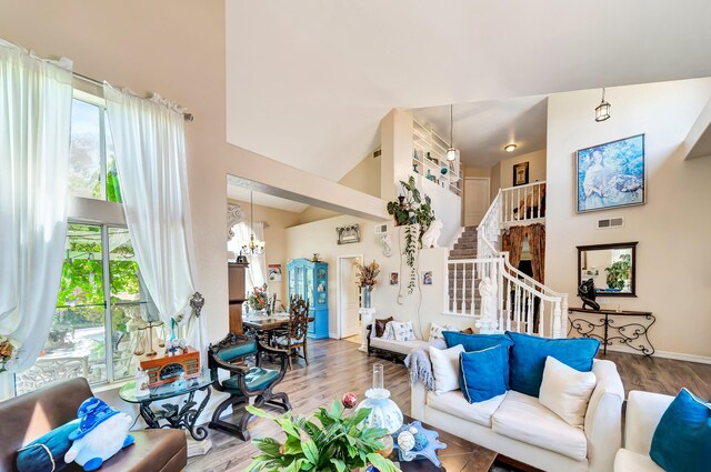 39884 Golfers Dr, Palmdale, CA 93551 - living room with a high ceiling, a chandelier, stairs, and wood finished floors