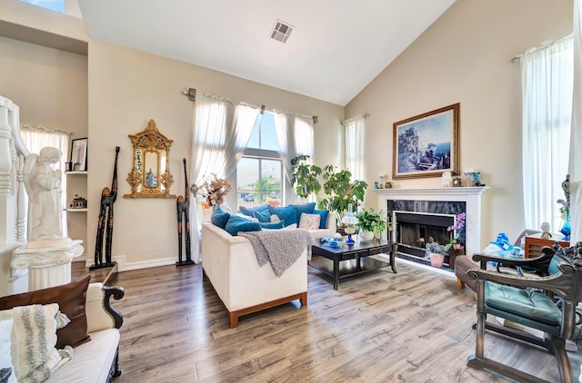 39884 Golfers Dr, Palmdale, CA 93551 - living area featuring high vaulted ceiling, wood finished floors, a high end fireplace, and baseboards
