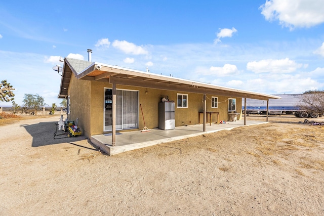 back of house with a patio