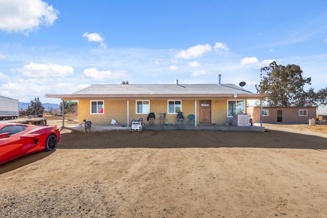 view of front of home with cooling unit and covered porch