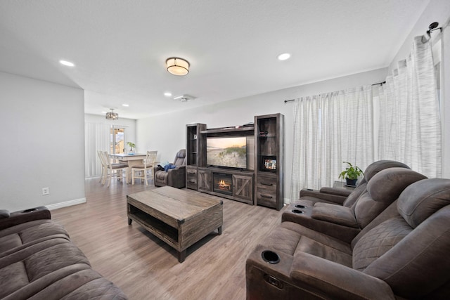 living room featuring a fireplace and light hardwood / wood-style floors