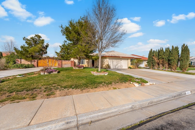 view of front facade featuring driveway, a gate, fence, a front yard, and an attached garage