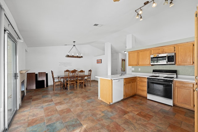 kitchen featuring stainless steel microwave, visible vents, a peninsula, white dishwasher, and gas stove