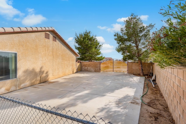 view of patio with a gate and fence