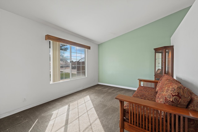 sitting room featuring vaulted ceiling, baseboards, and carpet floors