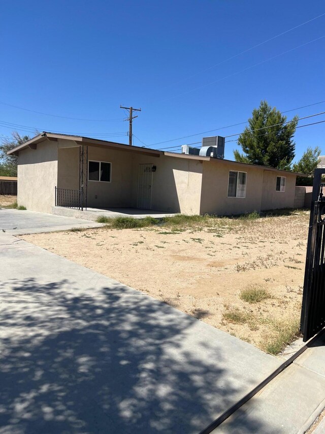 3354 Arthur Ave, Mojave, CA 93501 - view of front of home featuring stucco siding, cooling unit, and a patio area