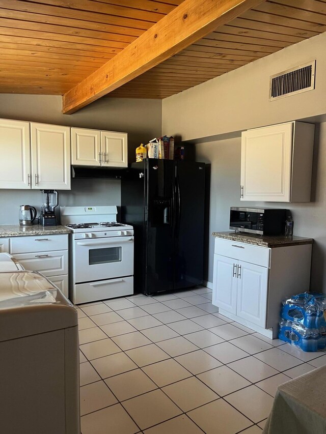 3354 Arthur Ave, Mojave, CA 93501 - kitchen featuring white gas range, black fridge, stainless steel microwave, wooden ceiling with exposed beams, and light tile patterned floors