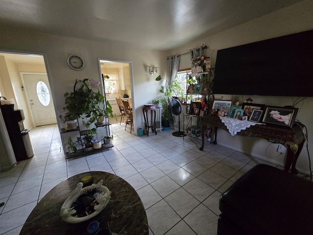 living area featuring plenty of natural light and light tile patterned floors