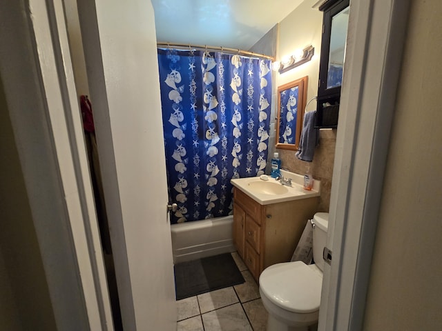 bathroom featuring vanity, tile patterned flooring, shower / bath combo with shower curtain, and toilet