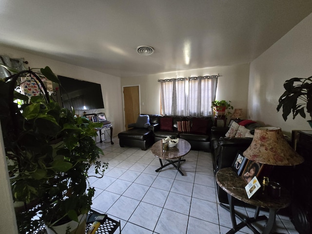 living area with light tile patterned flooring and visible vents