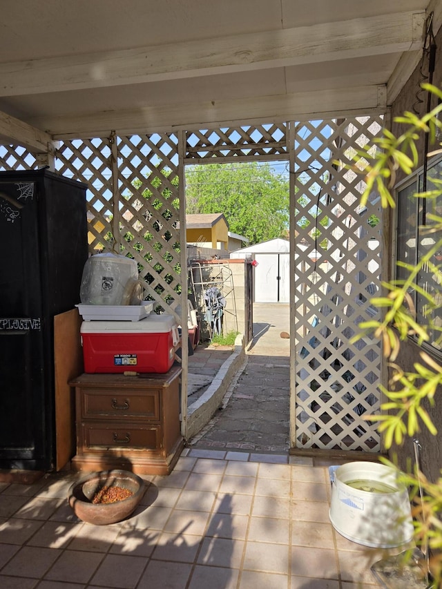 view of patio with an outbuilding and a shed