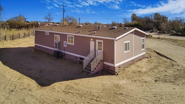 rear view of house with central AC unit