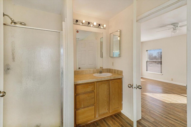 bathroom featuring hardwood / wood-style floors, vanity, ceiling fan, and a shower with shower door