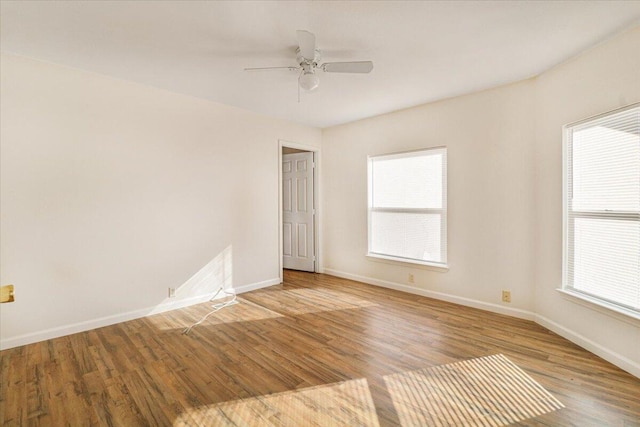 empty room featuring plenty of natural light, light hardwood / wood-style floors, and ceiling fan