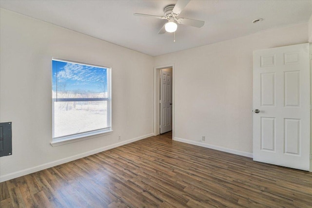 unfurnished room with dark hardwood / wood-style flooring and ceiling fan