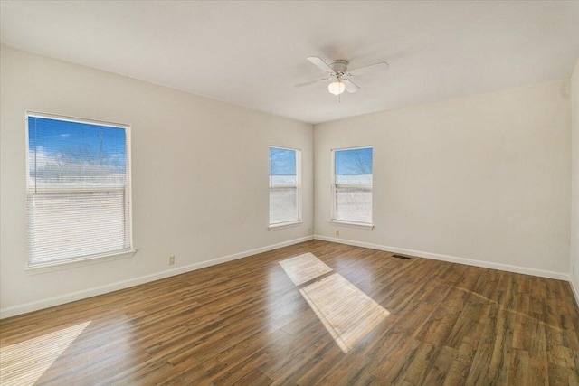 unfurnished room featuring ceiling fan and dark hardwood / wood-style flooring