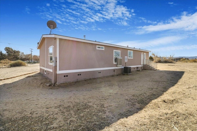 back of house with central AC unit