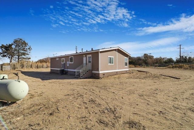 back of house featuring central AC unit