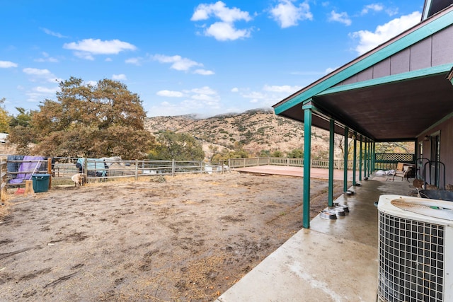 view of yard with a mountain view, cooling unit, and an outdoor structure