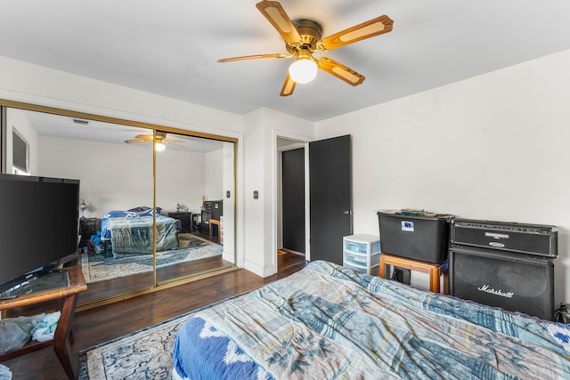 bedroom with dark hardwood / wood-style flooring, a closet, and ceiling fan