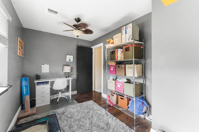 office area with ceiling fan and dark hardwood / wood-style floors