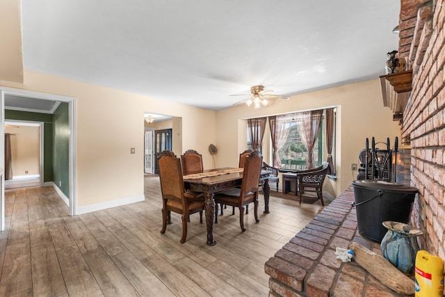 dining space featuring ceiling fan, light hardwood / wood-style flooring, and ornamental molding