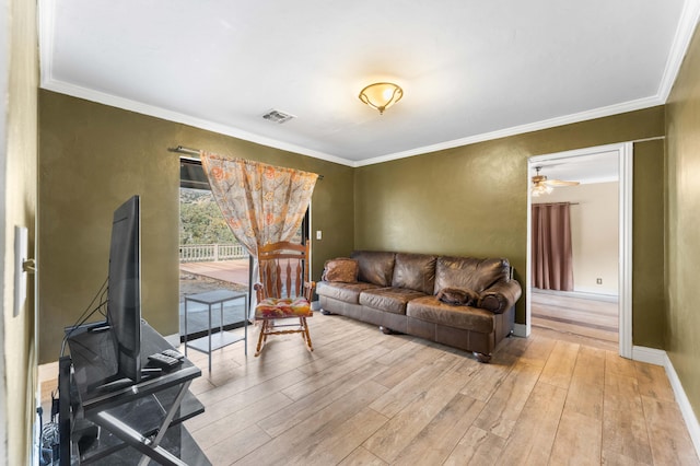 living room featuring crown molding and light hardwood / wood-style flooring