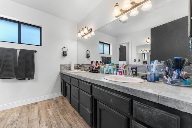 bathroom with hardwood / wood-style flooring, plenty of natural light, and vanity