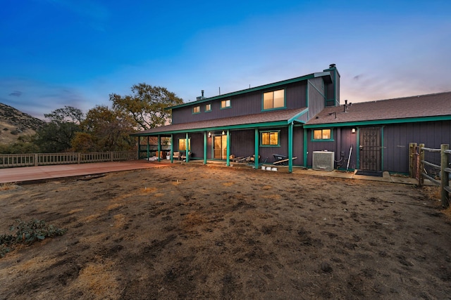 back house at dusk with cooling unit