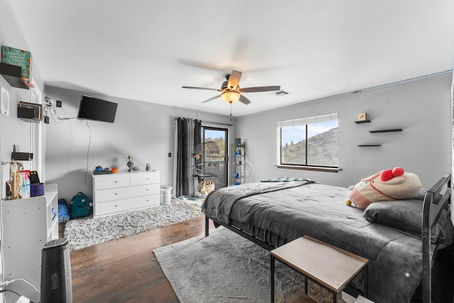 bedroom with hardwood / wood-style floors and ceiling fan