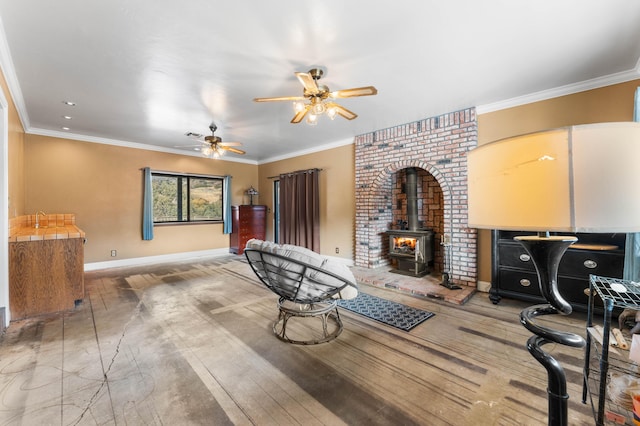 interior space with ceiling fan, a wood stove, and crown molding