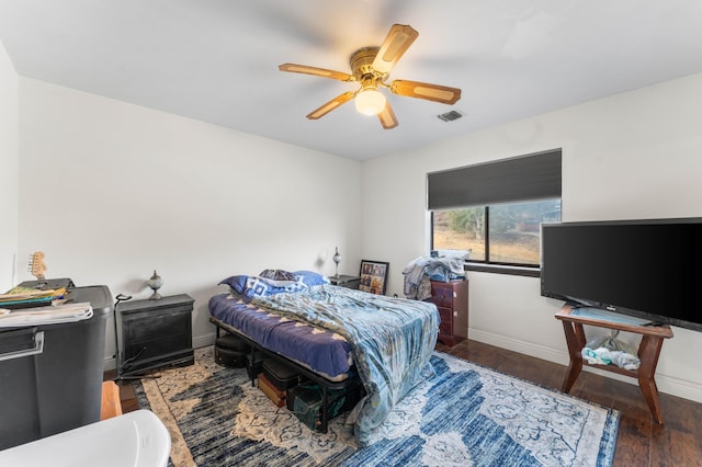 bedroom featuring ceiling fan and dark hardwood / wood-style flooring